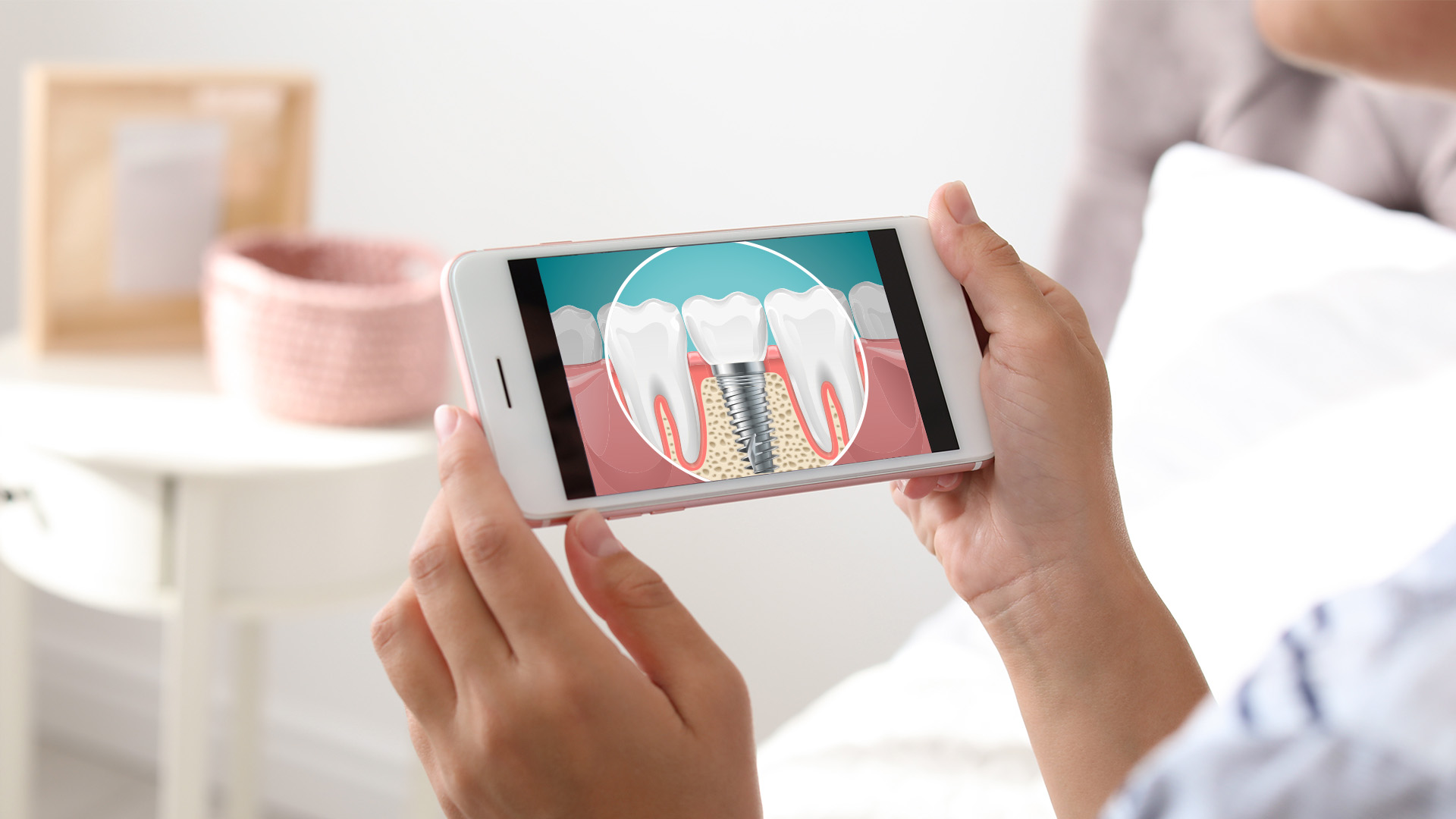 The image shows a person holding a smartphone displaying an image of a tooth with a visible crack, likely indicating a need for dental repair.