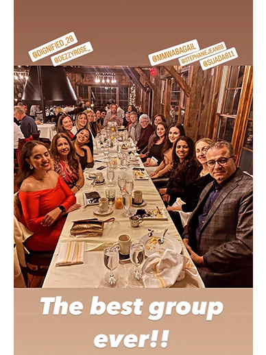 The image shows a group of people seated at a dining table, likely at a restaurant, with a warm ambiance and a celebratory atmosphere, indicated by the text on the image.